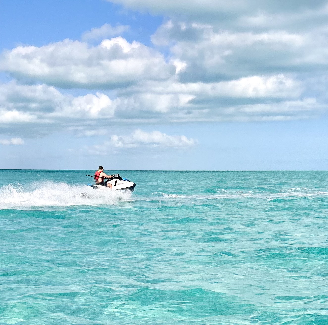 Jet ski cruising the turquoise water of the Caicos Cays