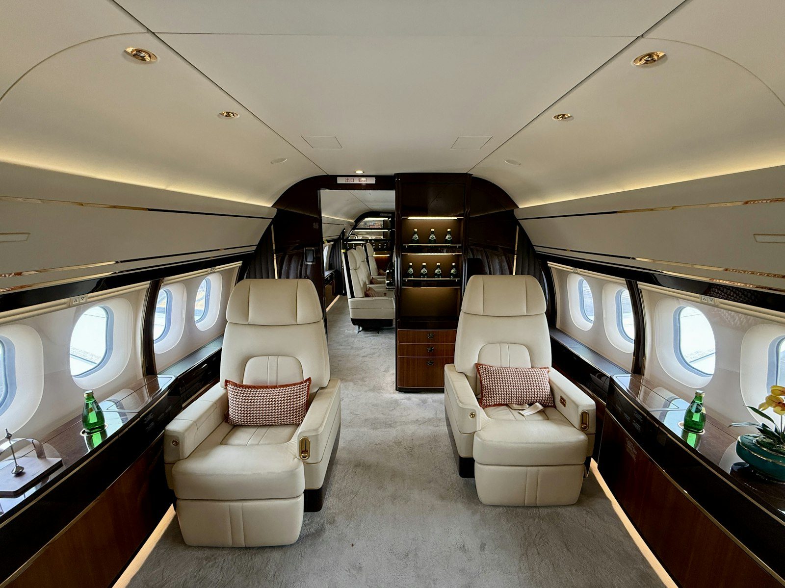 Luxury private jet cabin with cream leather seats before a charter flight to Providenciales