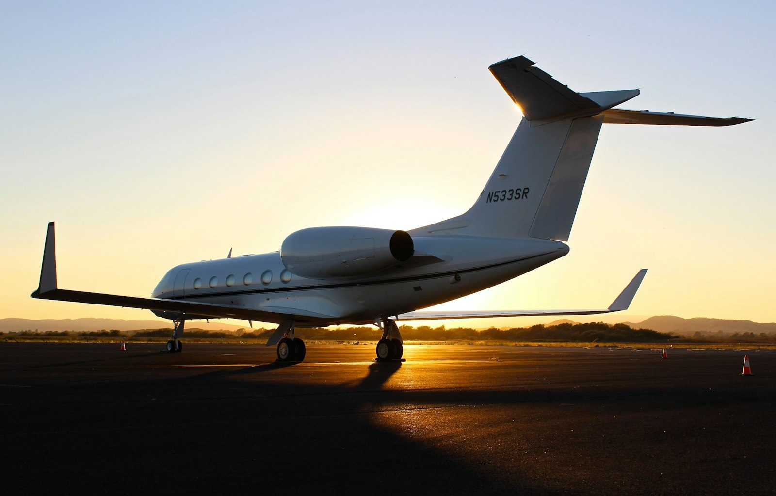 Private jet on the tarmac at sunset before a flight to Turks and Caicos